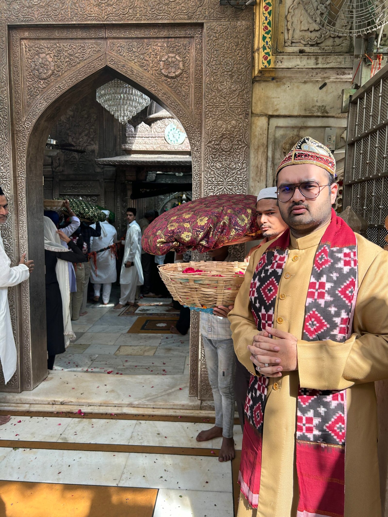 A patterned chadar covered with rose petals