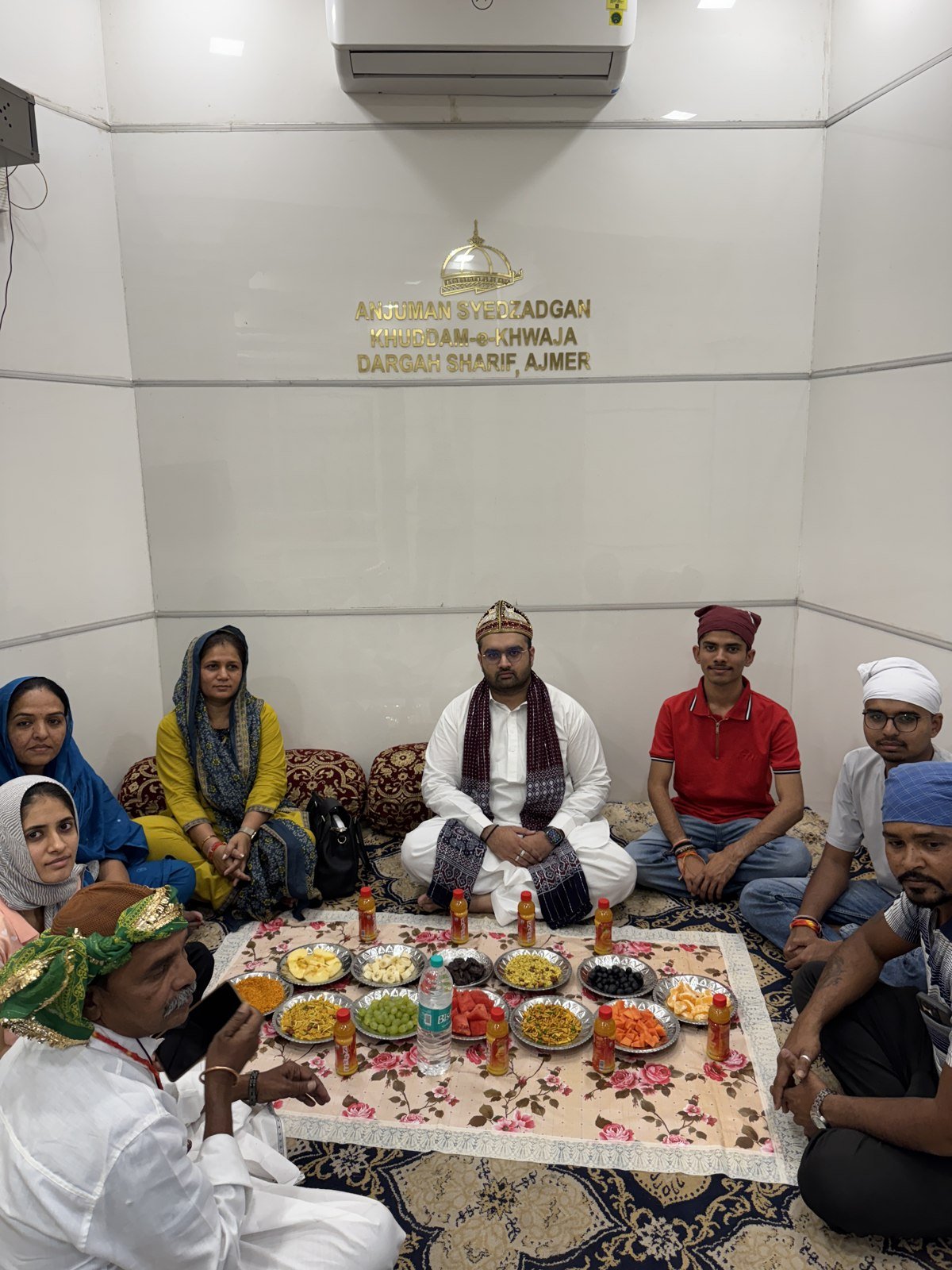 Visitors seated around a shared meal in the supplied office photo collection